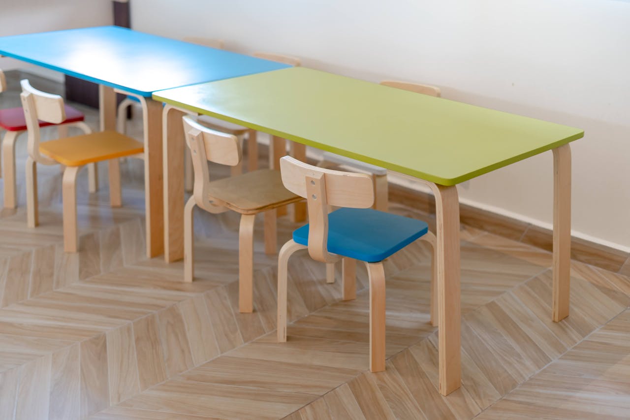 services-bg Vibrant child-sized chairs and tables in an educational setting.